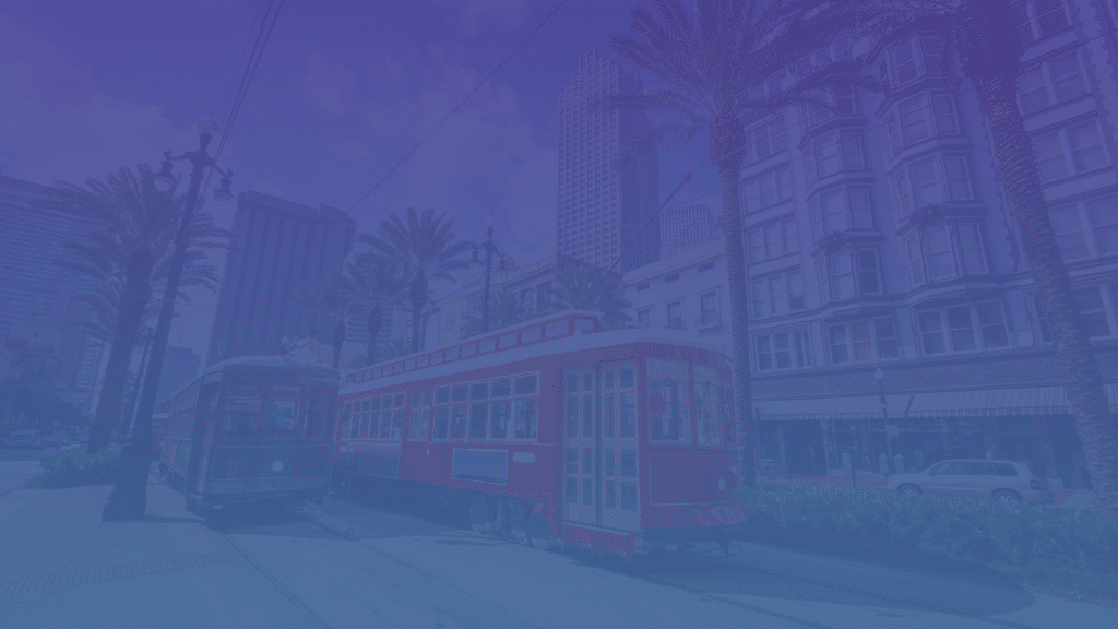 Street view of Canal Street with red street cars and palm trees