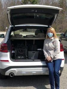 Principal With Face Mask Delivering Chromebooks in Car