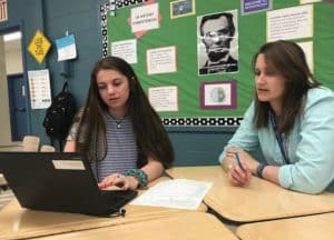 Epping High School teacher Katie Closs reviews a student’s collection of evidence during a student-led conference related to work study practices