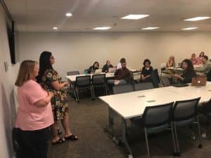 Ten teachers with two presenters at the front.