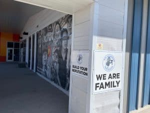 Outside of ACE HS with affirming signs and murals