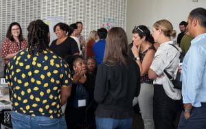 Groups of participants listen during the showcase