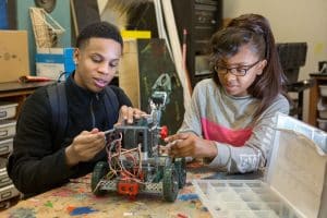 Ninth-grade students assemble a robot in an engineering class at MC2 STEM High School.