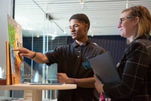 A student explains the inspiration for his painting.