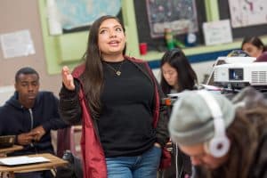 A student shares her research results during a class presentation.