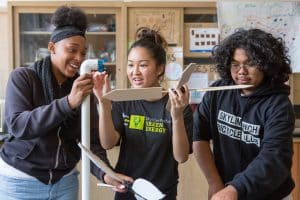 Students assemble a model wind turbine they constructed.