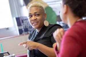 A middle school teacher shares her ideas during a team planning session.