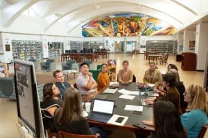 Teachers meet around a table