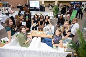 Group of students in the exhibition hall at Aurora Symposium