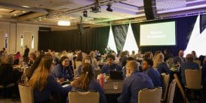 Leaders collaborating at a table at Symposium.