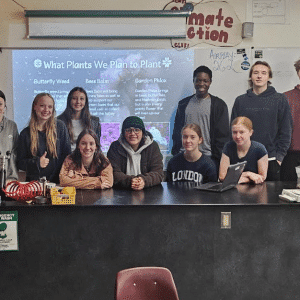 Students posing in front of their class presnentation