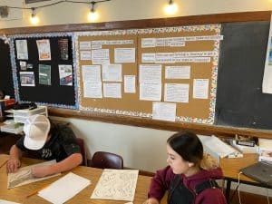 photo of two students working in a classroom