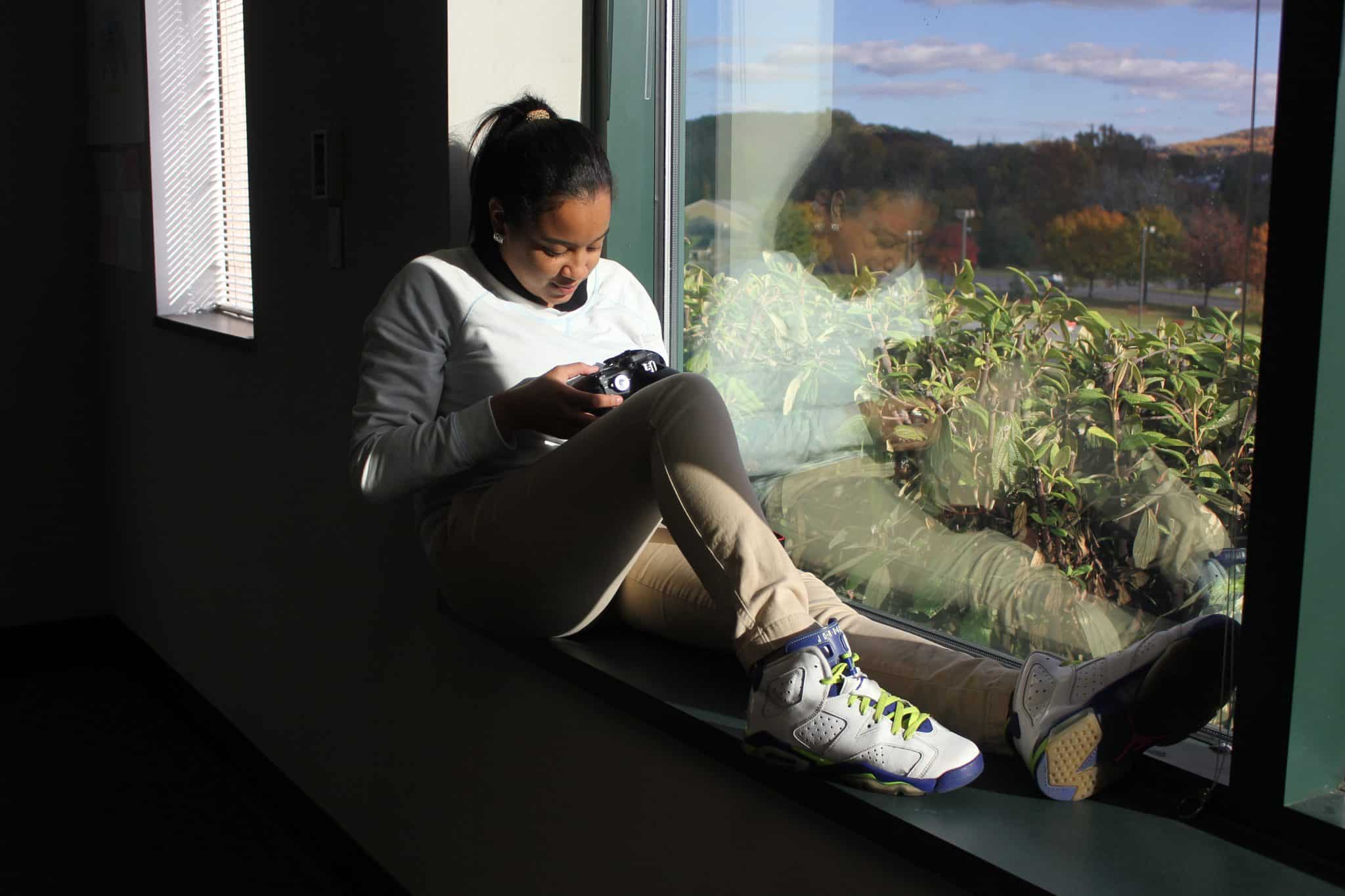 Student Sitting on Window Seat and Looking at a Camera