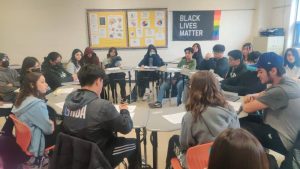 Students are participating in a Socratic circle in a classroom. 