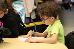 Student sitting at table looking at paper