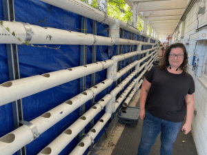 Christa Hollis by a hydroponic growing system at the Big Picture Learning school