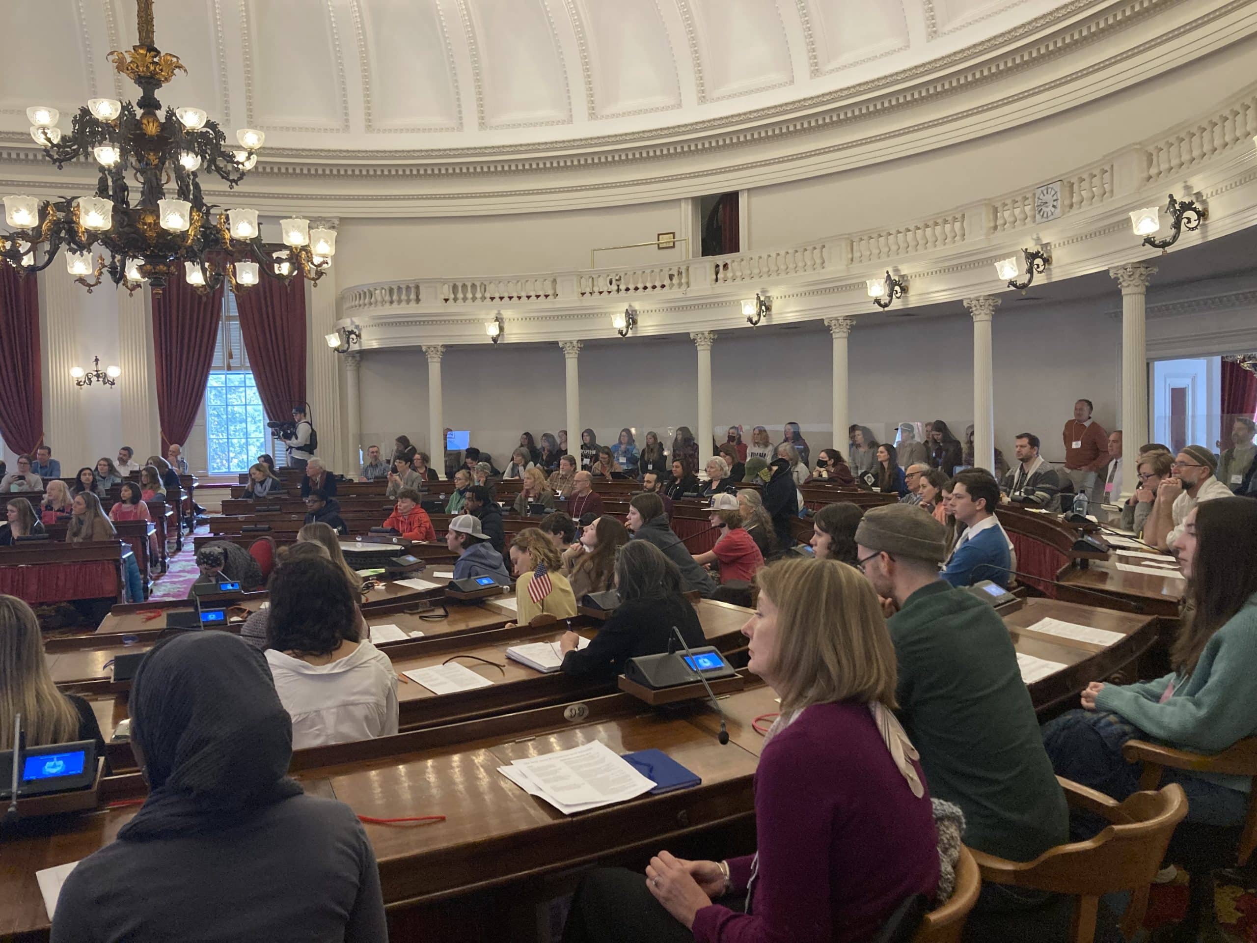 Event participants fill the VT State House Chamber