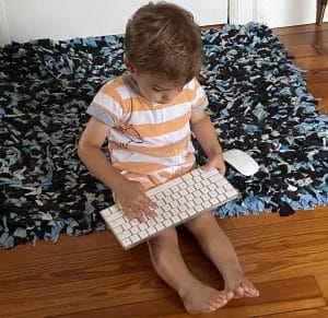 A toddler with a keyboard