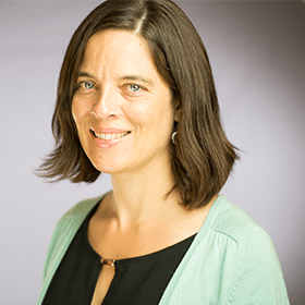 A headshot of Laurie Gagnon, Program Director of CompetencyWorks. Laurie smiles at the camera; she is wearing a black top and light green sweater.