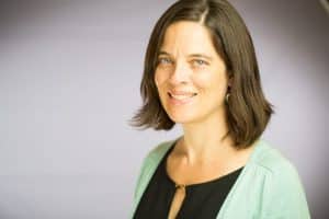 Headshot of Laurie Gagnon, CompetencyWorks program director. Laurie smiles at the camera wearing a black top and light green sweater.