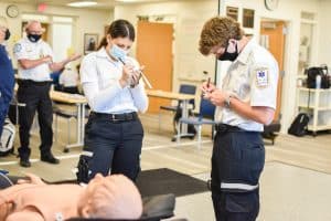 Two students participating in a EMT course.