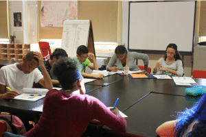 Group of students at BCS working around table