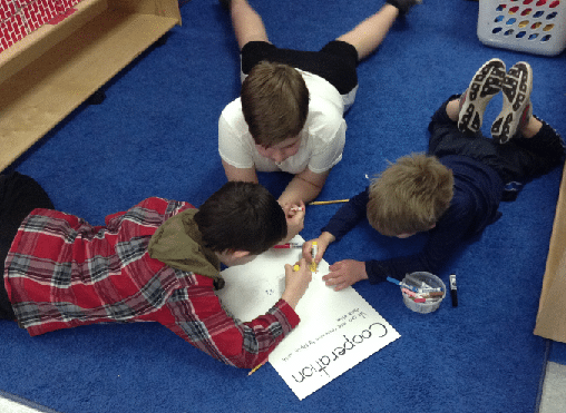 Students in Circle Working on Floor