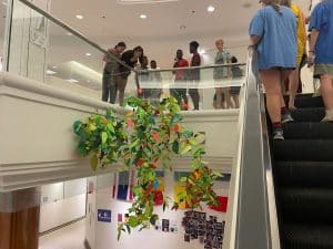 Flexible pathways students look at a leaf mobile art product