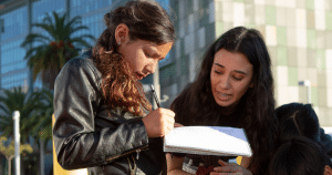 Student with notebook in garden