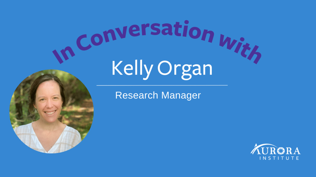 Image reads: In Conversation with Kelly Organ, Research Manager. Includes a headshot of Kelly smiling and the Aurora Institute logo.