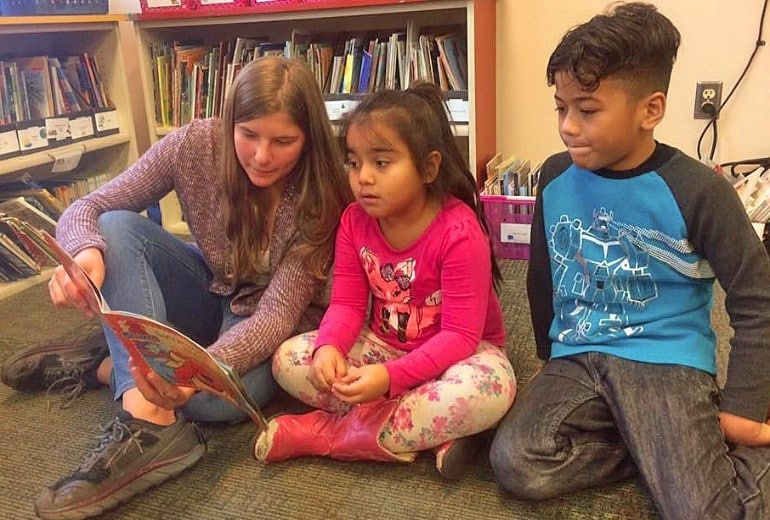 Whittier Student Reading to Younger Students