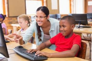 bigstock-Cute-pupils-in-computer-class--85201370--reduced