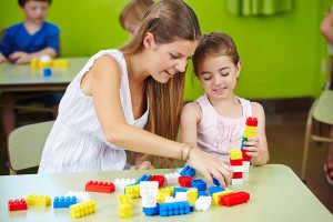 bigstock-Nursery-teacher-and-girl-playi-67565977--web