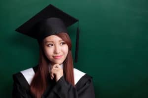 A graduating student in cap and gown. 