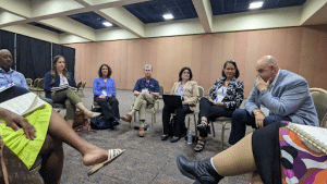 Participants at the Aurora Institute Symposium sitting in a discussion circle about belonging. 