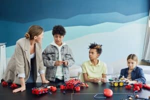 Teacher and three students working on an engineering project