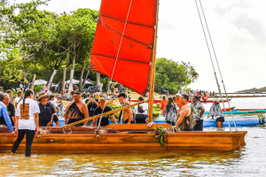 Group boarding Indigenous canoes